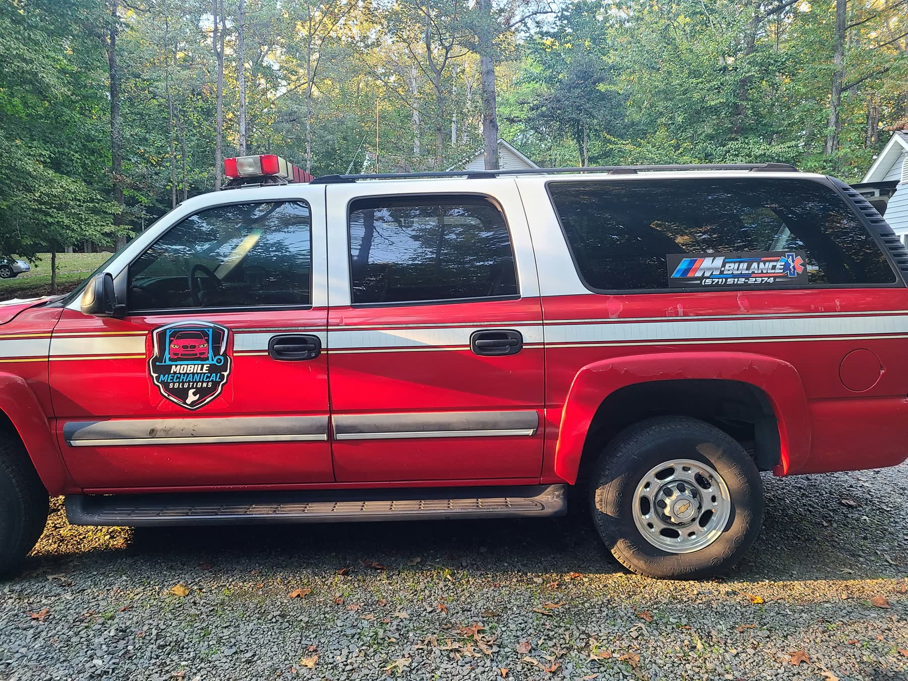 The M-bulance: Mobile Mechanical Solutions red service truck with BMW M-stripe decal